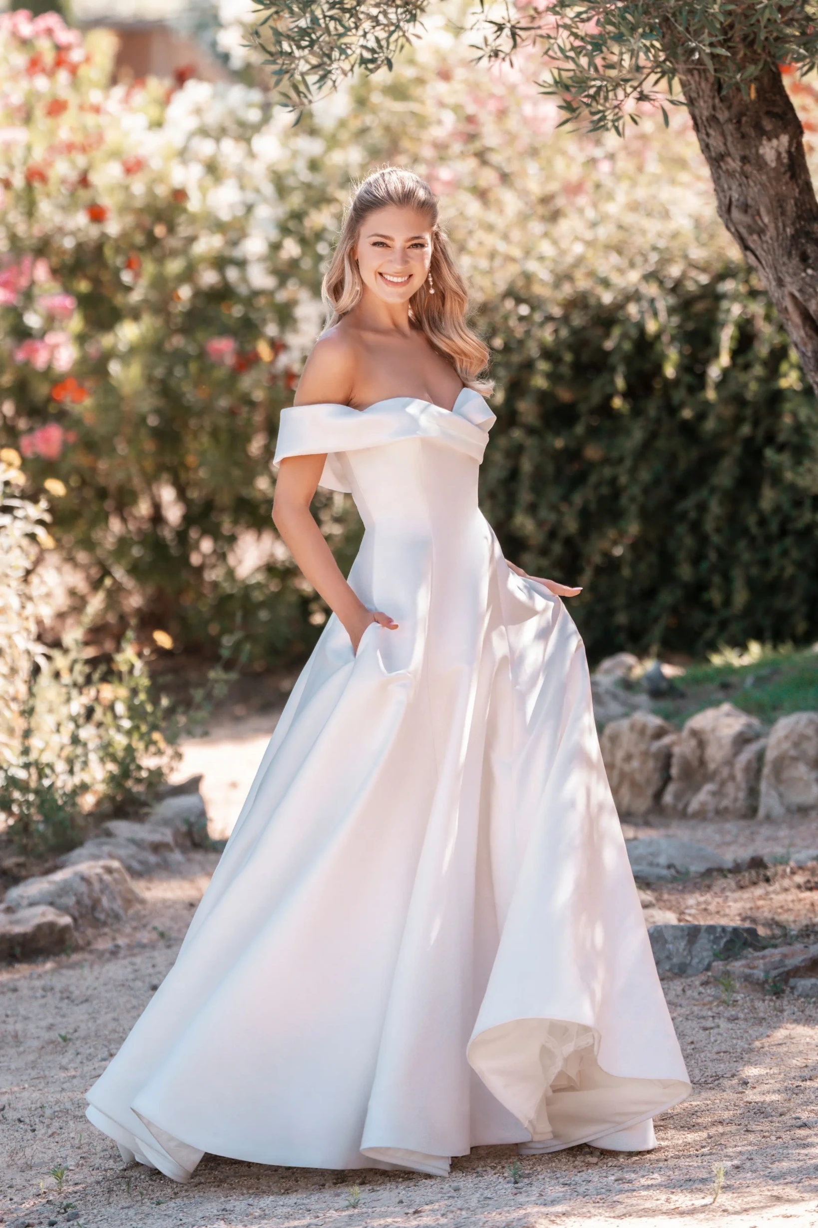 Model wearing a white gown by allure bridals