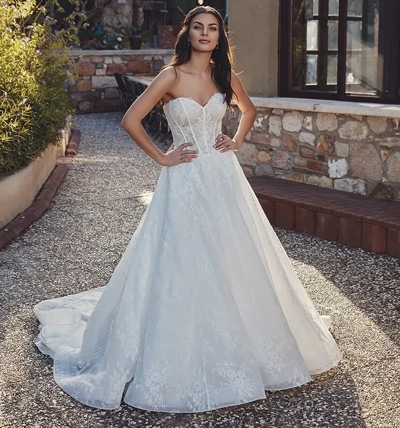 Model wearing a white gown by Eddy K