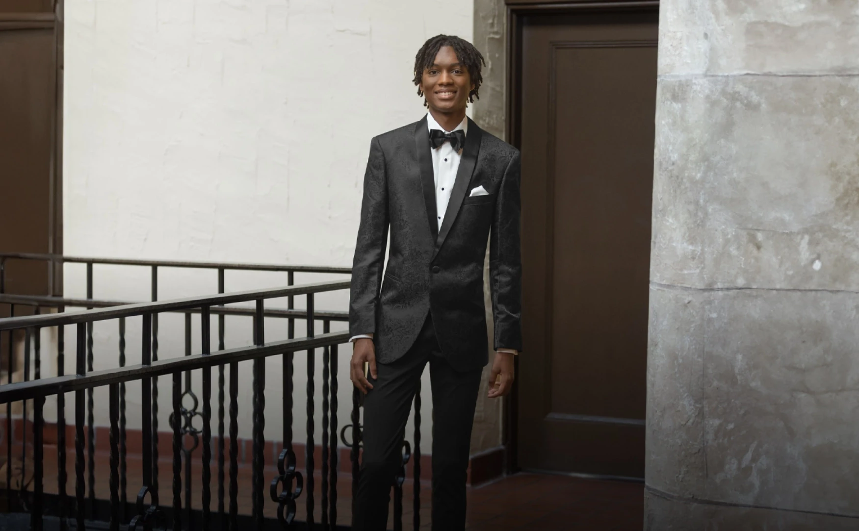 Man wearing black tuxedo.