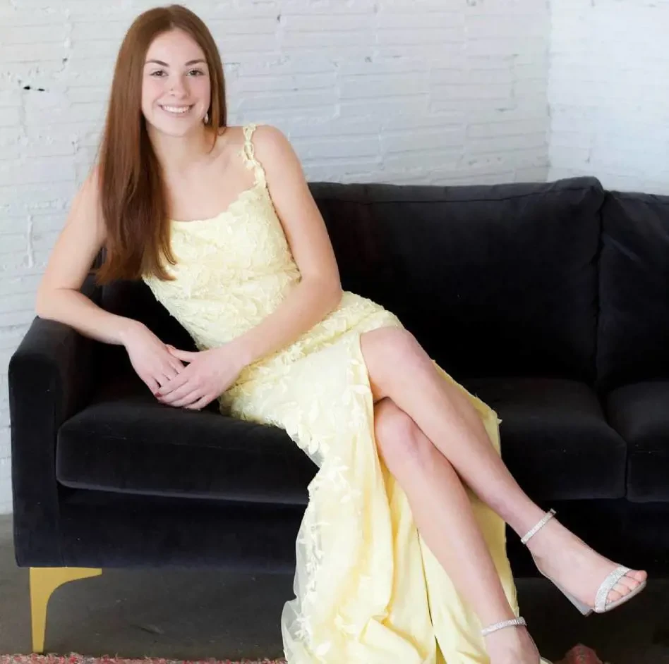 A girl wearing a yellow dress
